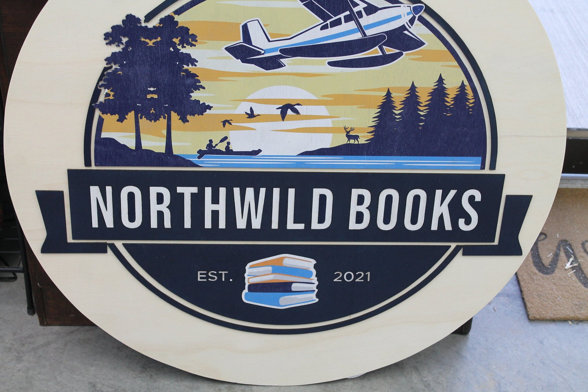 Book Store Small Business Logo Custom Round Sign Printed In Color Raised Lettering Sunset Airplane Commerical Store Front Signage
