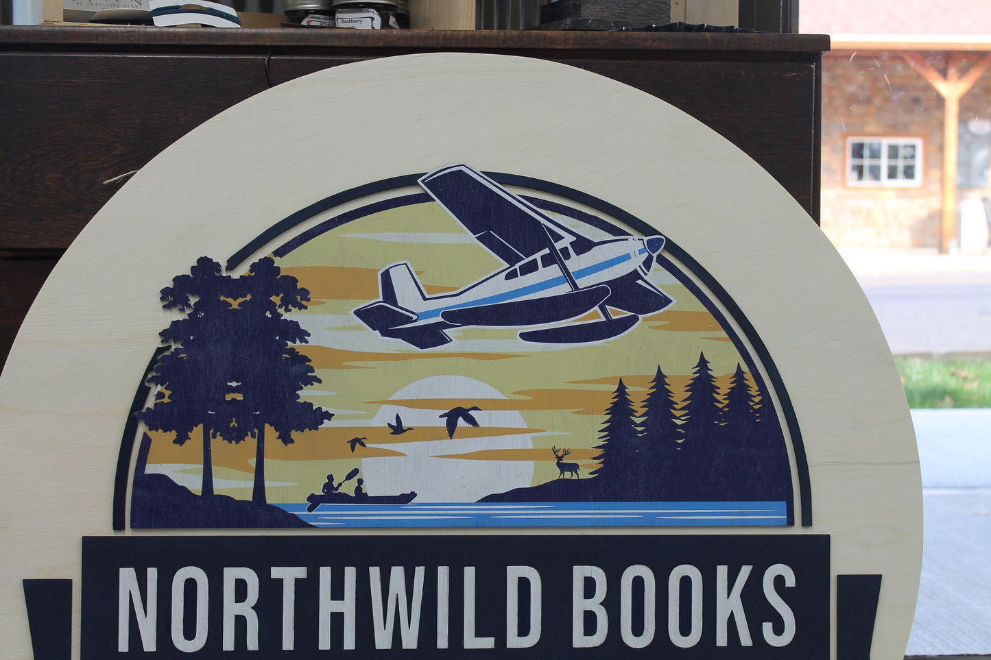 Book Store Small Business Logo Custom Round Sign Printed In Color Raised Lettering Sunset Airplane Commerical Store Front Signage